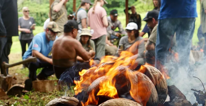 Group fire cooking in Hawaii jungle